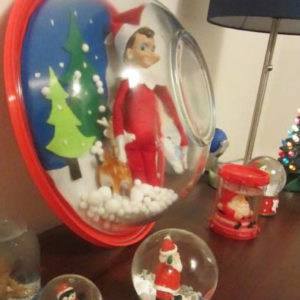 elf on shelf in snow globe 