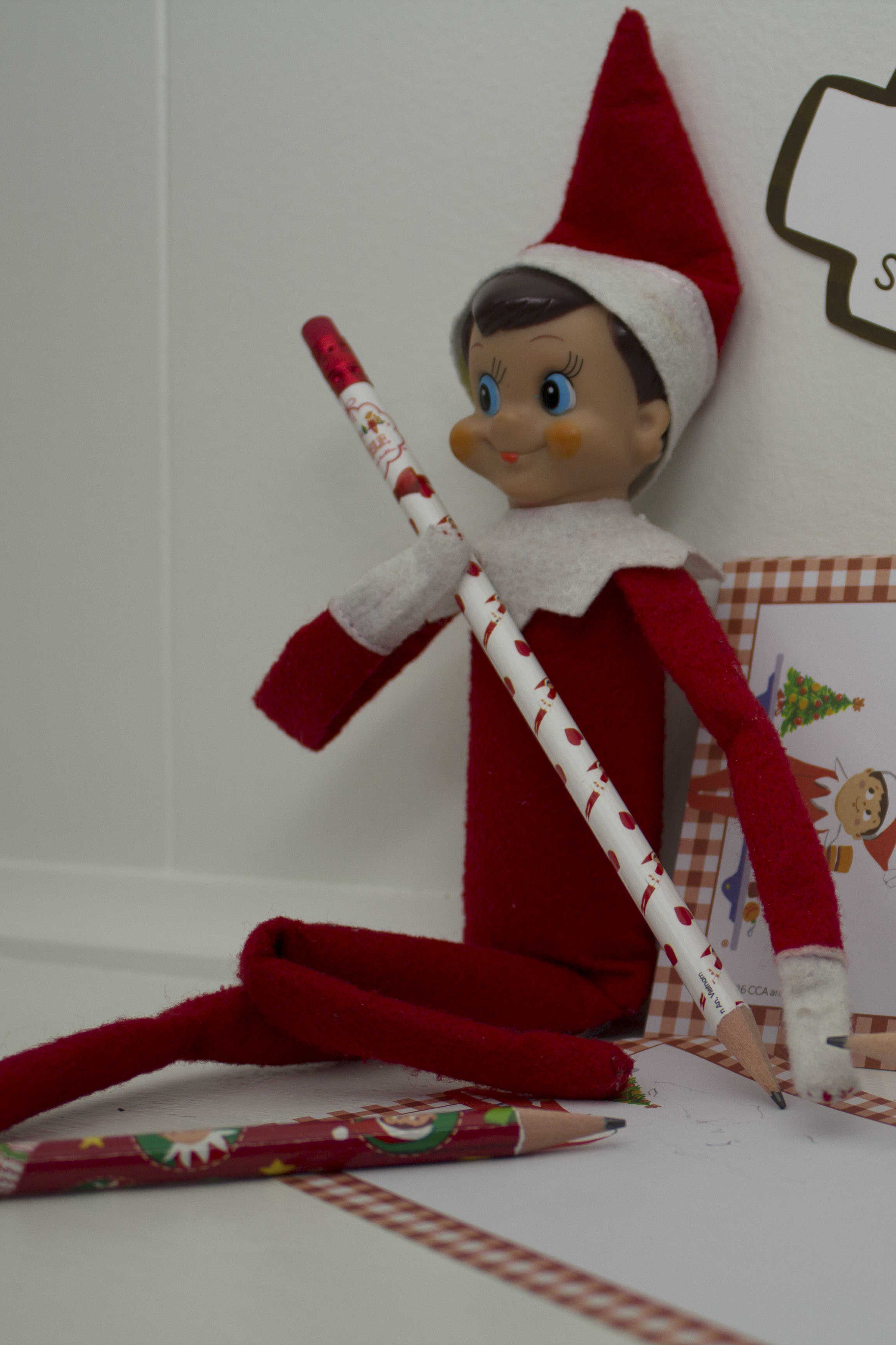 elf on the shelf with pencil