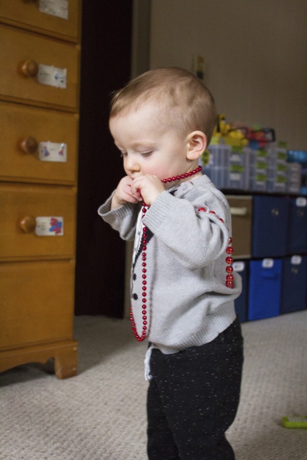 baby with red beads