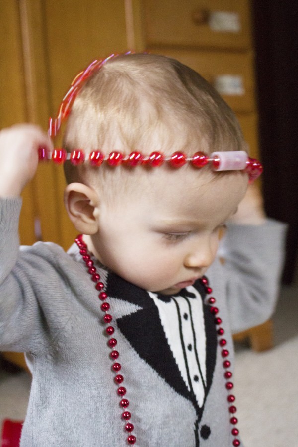 toddler with red necklace