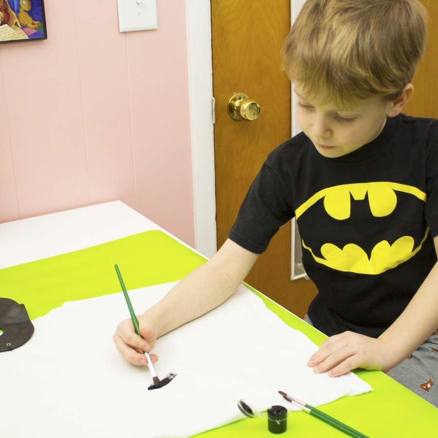 boy painting cape