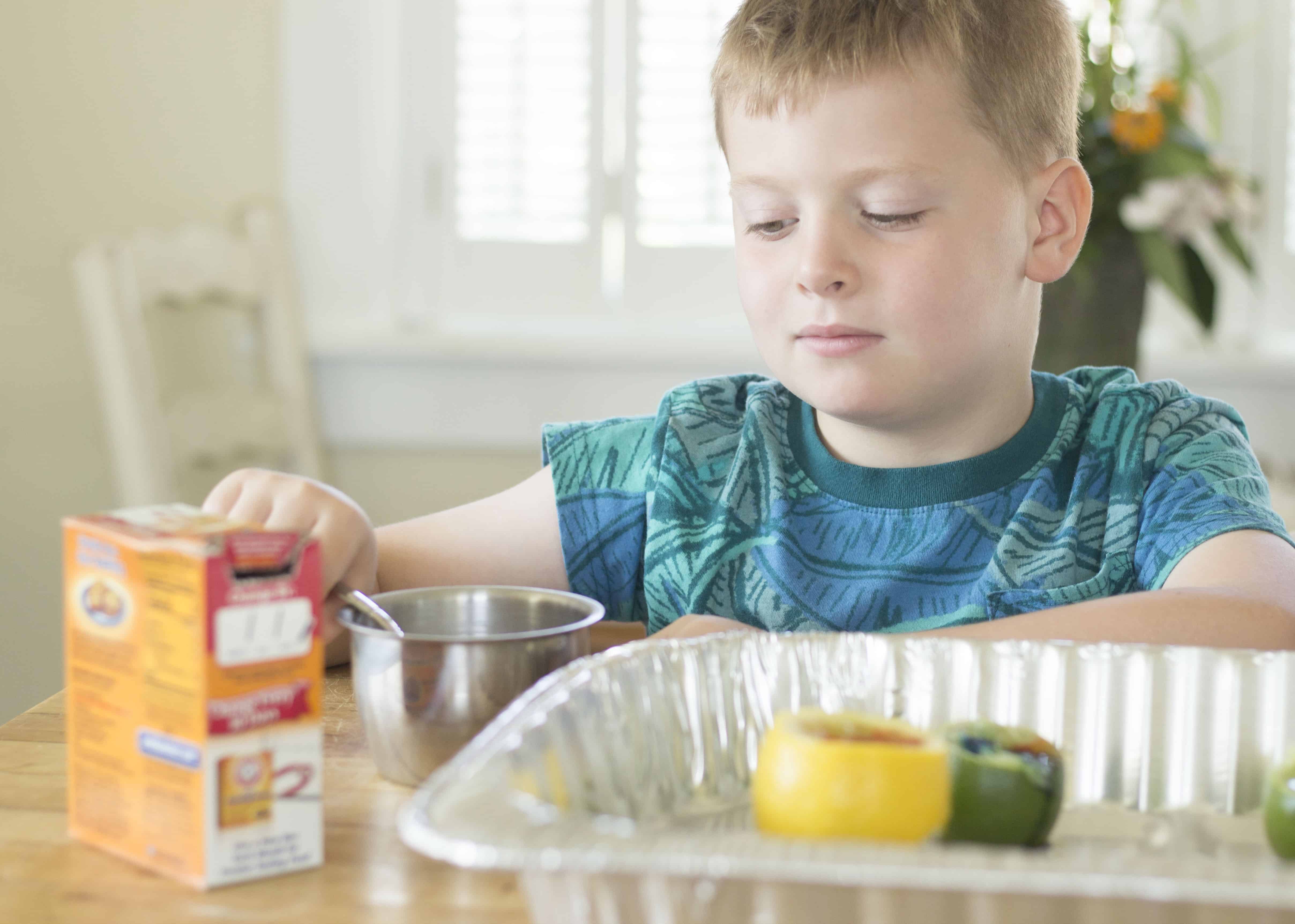 BOY CREATING CITRUS VOLCANO