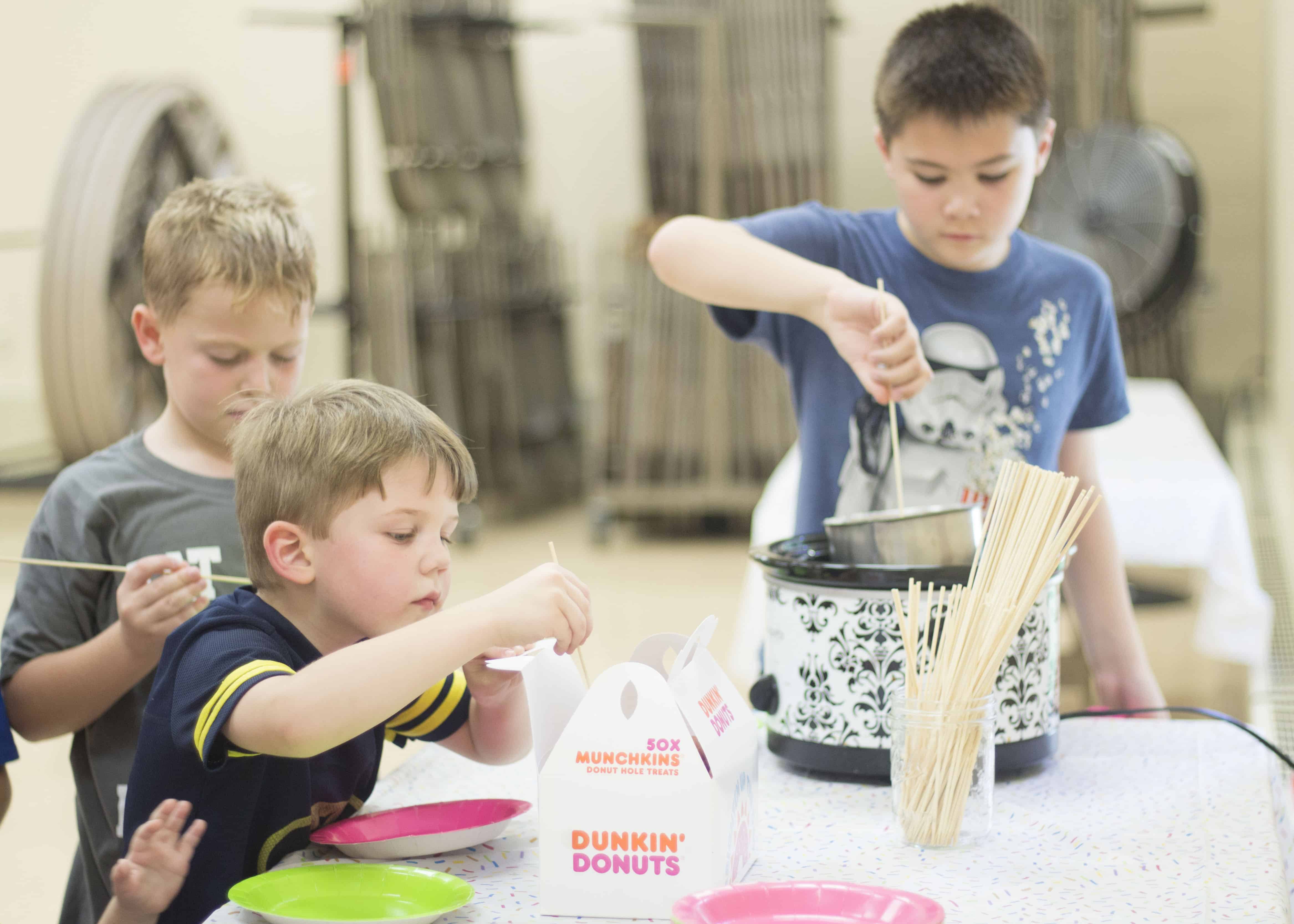 BOY DECORATING DONUT HOLE