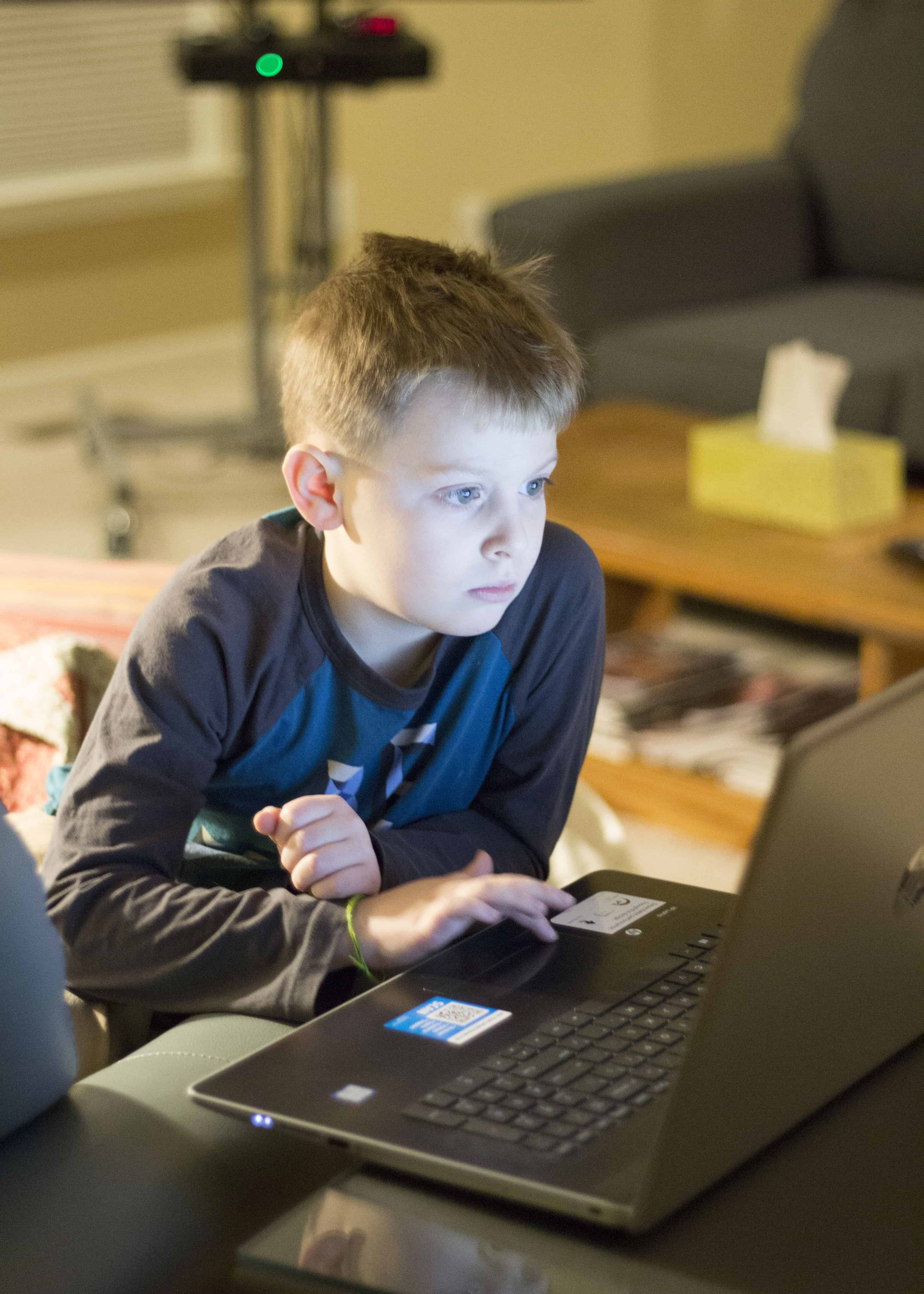 BOY PLAYING ON LAPTOP