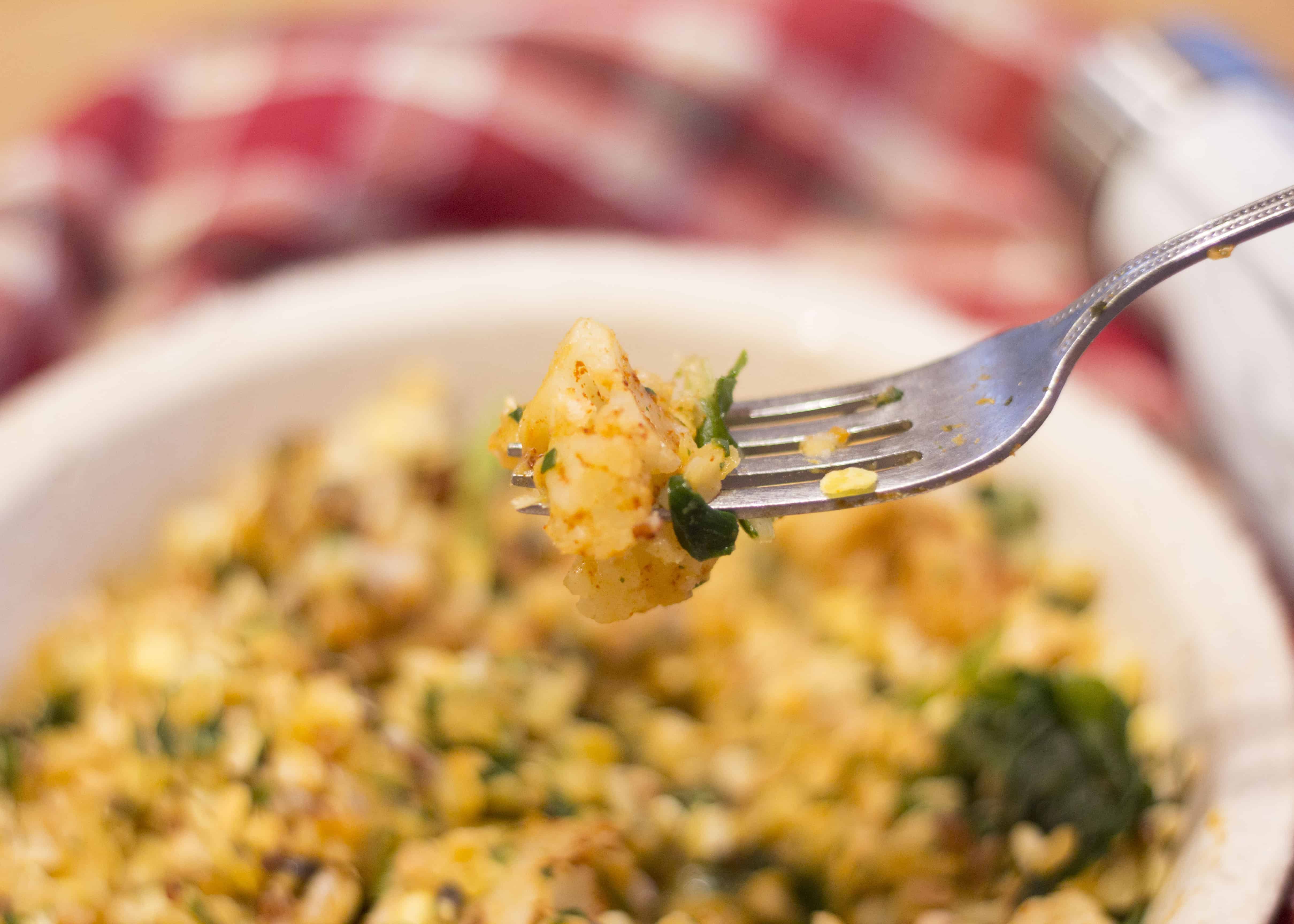 eating cauliflower curry bowl