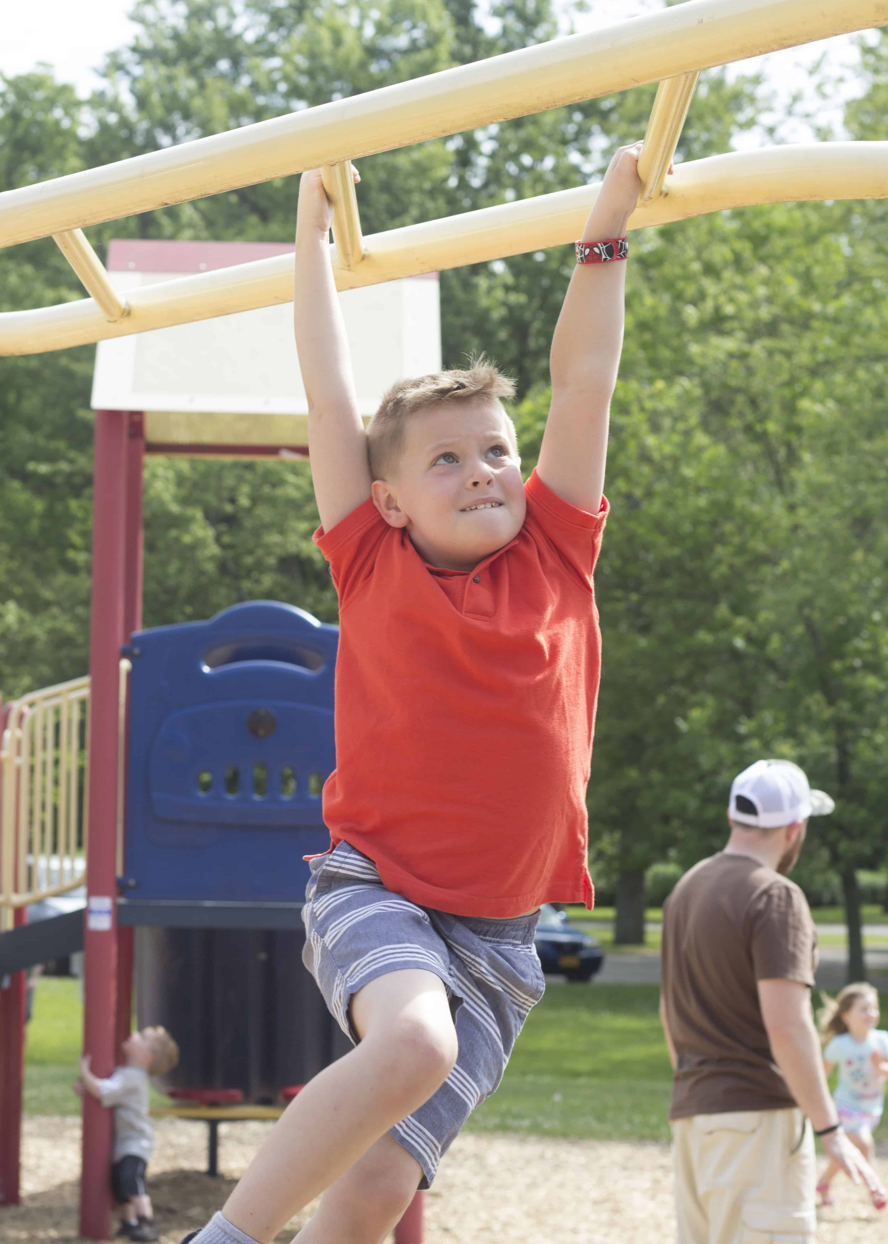 BOY PLAYING ON PLAYGROUND