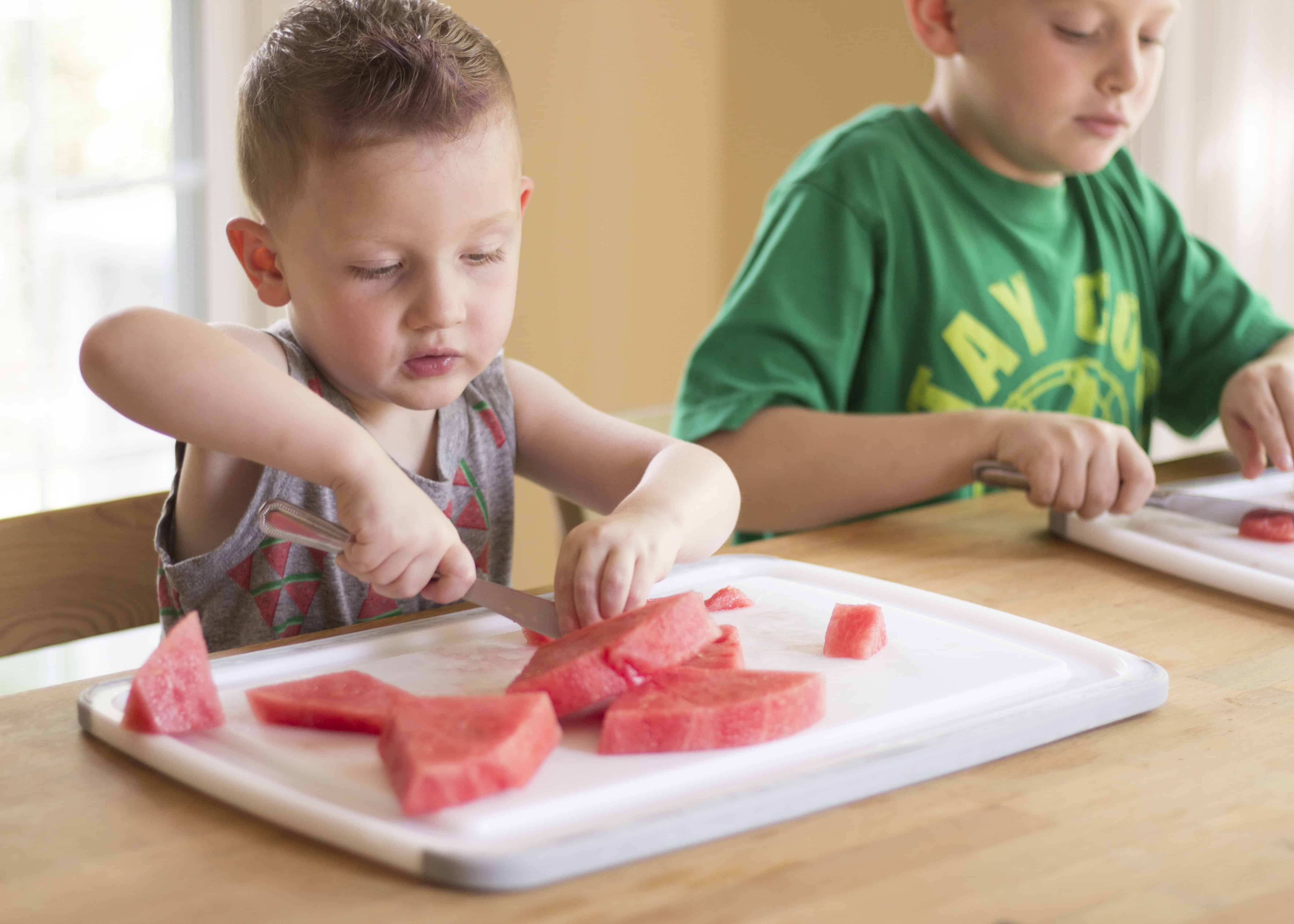 KIDS CUTTING WATERMELON