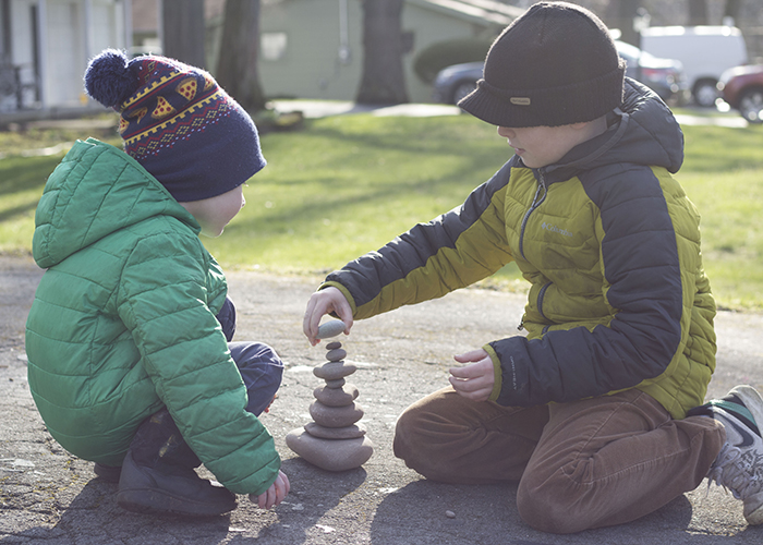 BOYS STACKING ROCKS