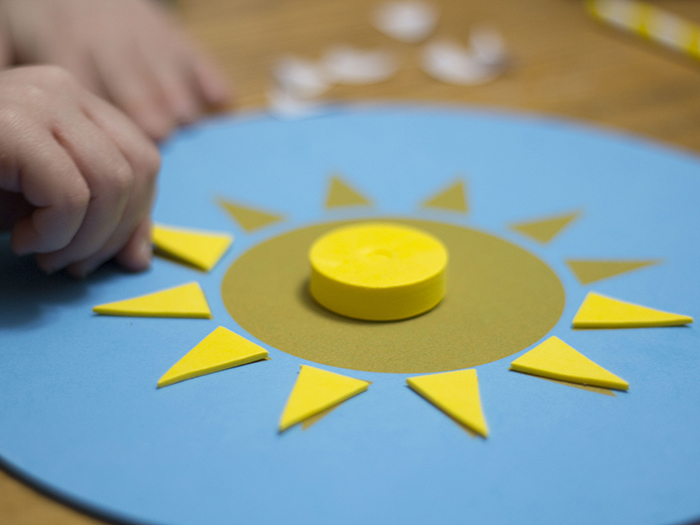 BOY MAKING SUNDIAL