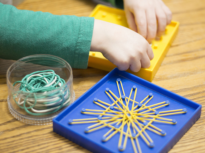 BOY WITH GEOBOARD