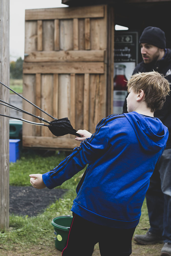 boy with apple slingshot