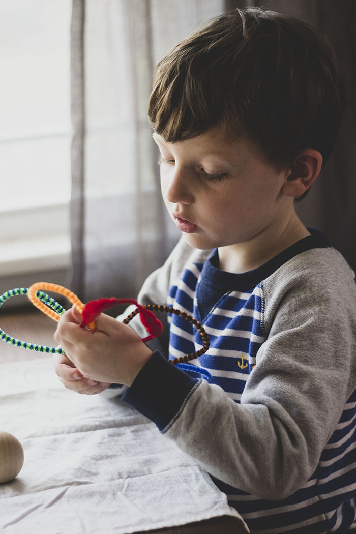 BOY TWISTING PIPE CLEANERS