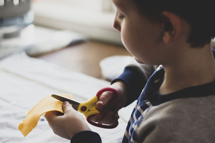 BOY CUTTING FELT 